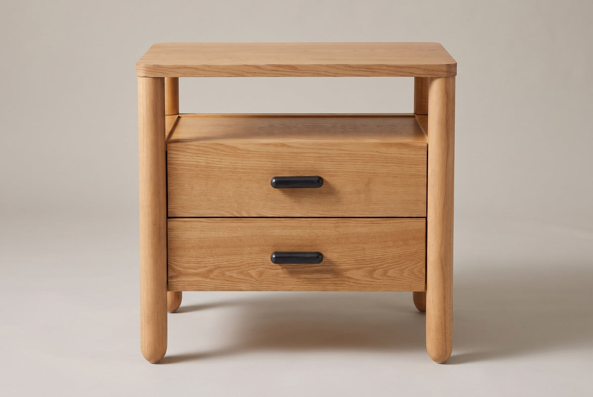 Montagnana nightstand, straight front view: rounded top, open shelf, two drawers with black capsule pulls, four round posts