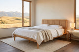 Montalcino cane bed in evening light beside a window onto rolling foothills and mountains