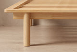 Close-up of the Montalcino frame corner: rounded rim, recessed apron and a round wooden leg