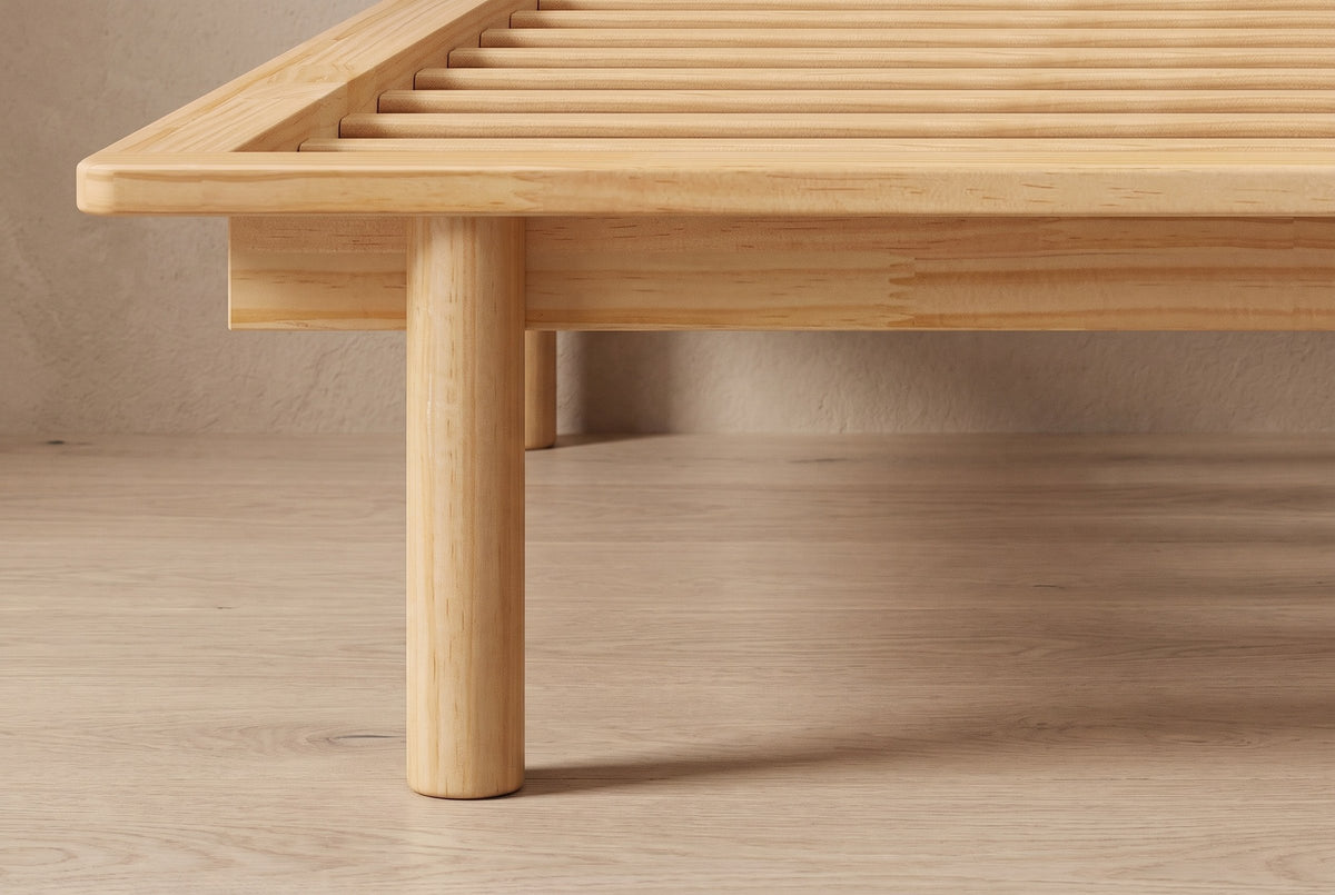 Close-up of the Montalcino frame corner: rounded rim, recessed apron and a round wooden leg