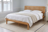 Montalcino cane bed in a pale blue bedroom with a harbour view and a striped rug