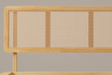Close-up of the Montalcino headboard: rounded wood corner, open-weave cane panels and one round post