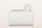 Montecassiano sofa in Cream from the side on a warm white studio backdrop: one smooth arm panel and a back cushion leaning ba