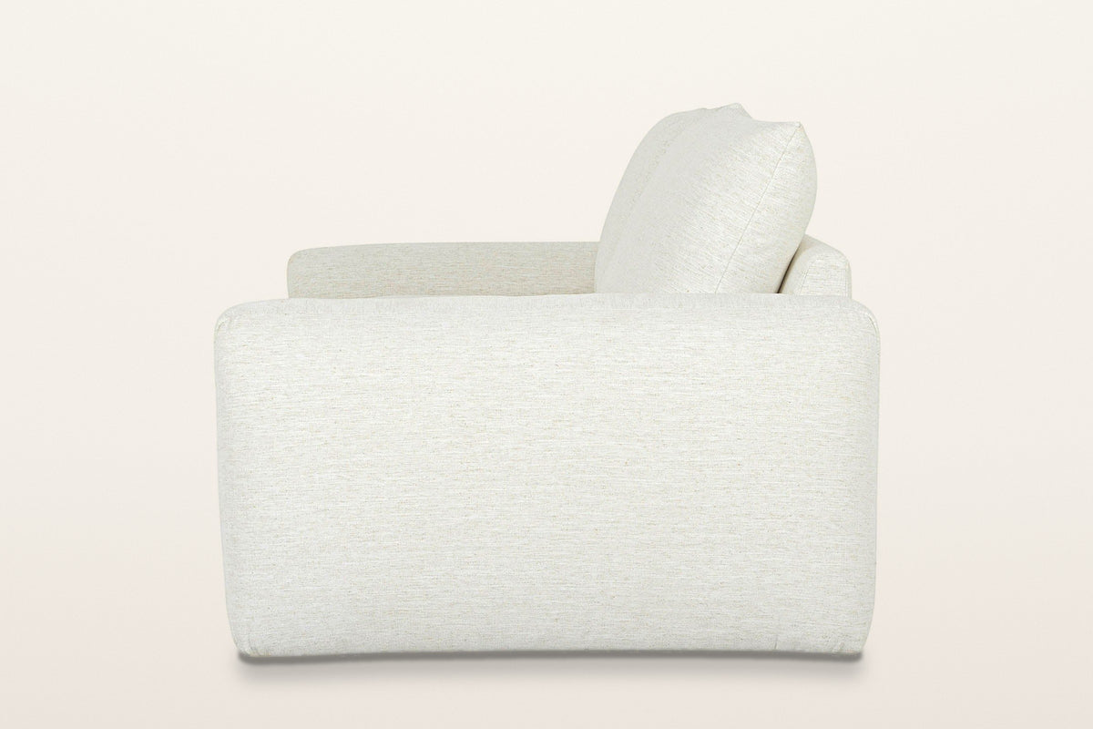 Montecassiano sofa in Cream from the side on a warm white studio backdrop: one smooth arm panel and a back cushion leaning ba
