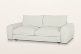 Montecassiano rounded arm sofa in Cream, three-quarter view on a warm white studio backdrop: thick domed arms