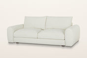 Montecassiano rounded arm sofa in Cream, three-quarter view on a warm white studio backdrop: thick domed arms