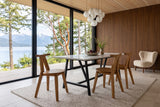 Montegiorgio dining chairs at a white marble table on a black steel base in a Denman Island house, seen from the corner