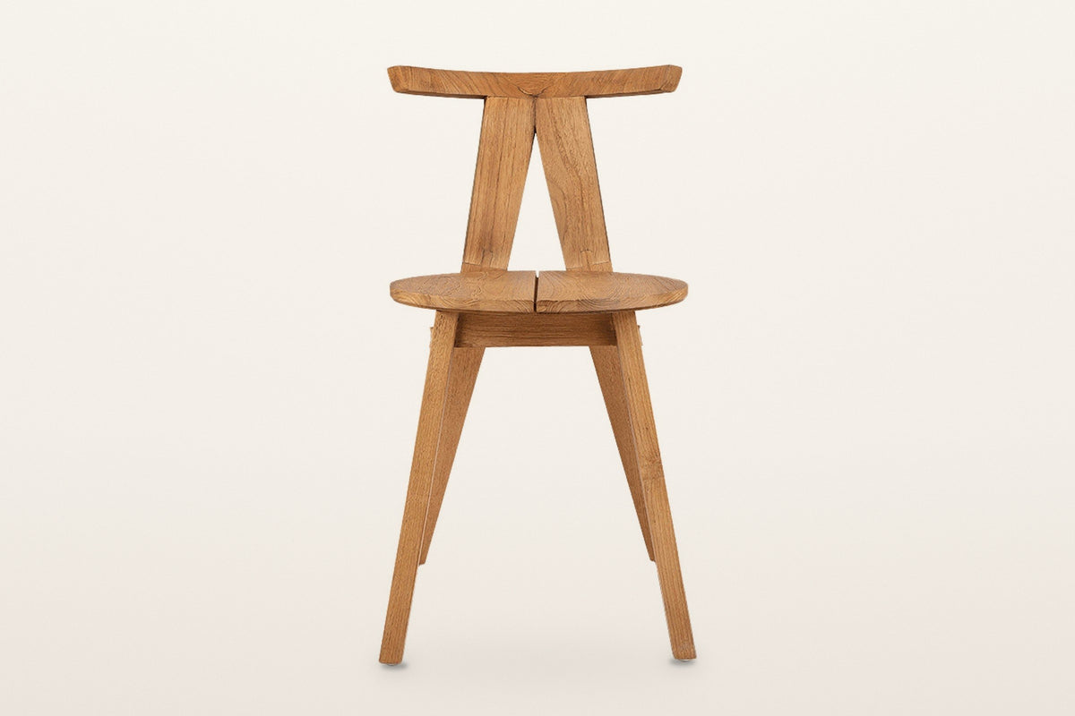 Montegiorgio dining chair, straight front view on a warm white studio backdrop: the two posts meet under the top rail in an i
