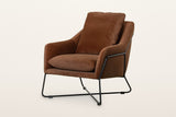 Montelupone accent chair in Rust, three-quarter view on a warm white studio backdrop
