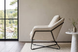 Montelupone accent chair in Taupe in side profile in a Burnstown house on the Madawaska River, greige plaster