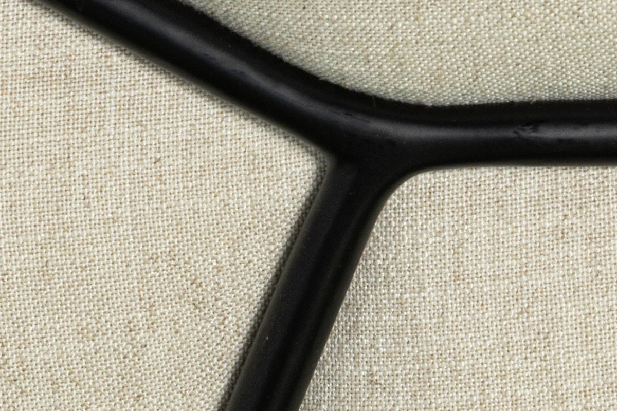 Close-up of the Montelupone frame: the black iron rod meets in a Y on the Taupe linen-blend fabric