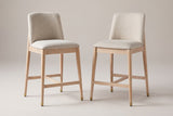 A pair of Monteriggioni counter stools side by side: squared beige back pads, flat padded seats