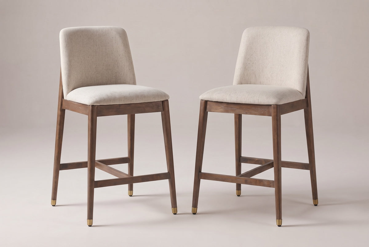 A pair of Monteriggioni counter stools in the walnut finish side by side: squared beige back pads, flat padded seats