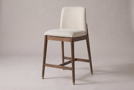 Monteriggioni counter stool with a brushed walnut-finish rubberwood frame and a beige upholstered seat and back pad