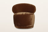 Monterubbiano accent chair in Bronze velvet, straight front view on a warm white studio backdrop: the rounded back above a ro