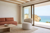 Monterubbiano accent chair in Ivory twill in a Carvoeiro cliff villa in the Algarve, tadelakt walls