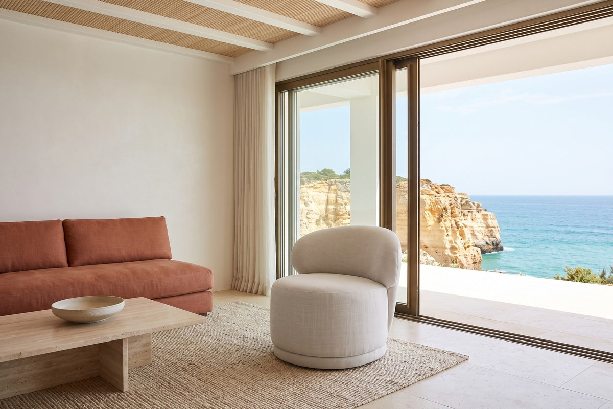 Monterubbiano accent chair in Ivory twill in a Carvoeiro cliff villa in the Algarve, tadelakt walls