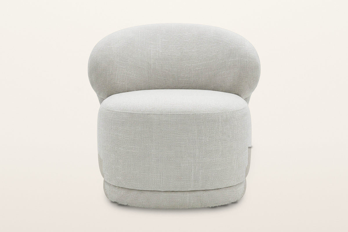 Monterubbiano accent chair in Ivory twill, straight front view on a warm white studio backdrop: the rounded back above a roun