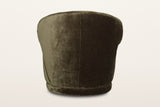 Back of the Monterubbiano accent chair in Khaki Green velvet on a warm white studio backdrop: one smooth curved shell