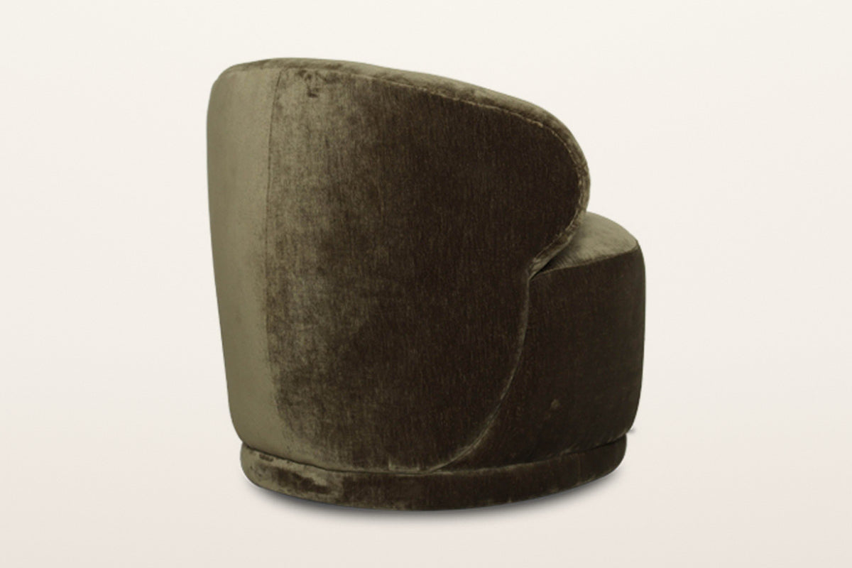 Monterubbiano accent chair in Khaki Green velvet from the back at three-quarter on a warm white studio backdrop