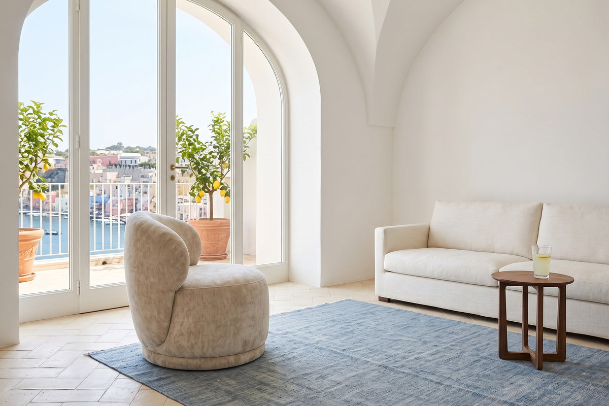 Monterubbiano accent chair in Natural velvet in side view in a Procida island house on the Bay of Naples
