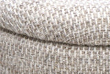 Close-up of the Morgex pouf: the padded lid's rounded edge over the drum, with a fine shadow line between them