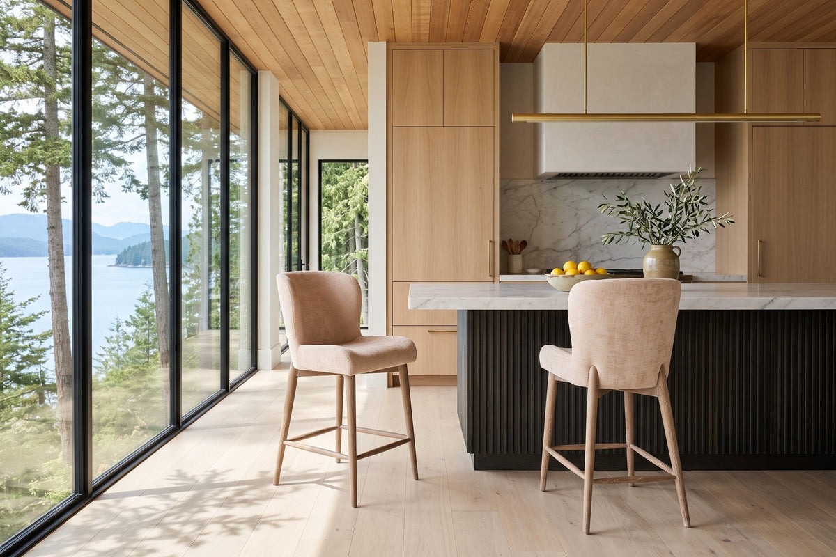Two Morrovalle counter stools in Champagne Chenille at a charcoal fluted-oak island with a white marble top in a Cortes Islan