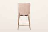 Morrovalle counter stool in Champagne Chenille from behind on a warm white studio backdrop: a plain upholstered back with one