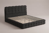 Nemi storage bed in black bouclé, three-quarter view of the bare frame with slats on a warm grey studio backdrop