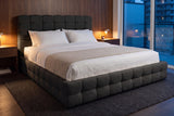 Nemi bed in black bouclé against walnut wall panels in a Toronto condo at dusk