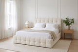 Nemi bed made up with white linen in a bright Montreal bedroom with wall mouldings, sheer curtains and light oak nightstands