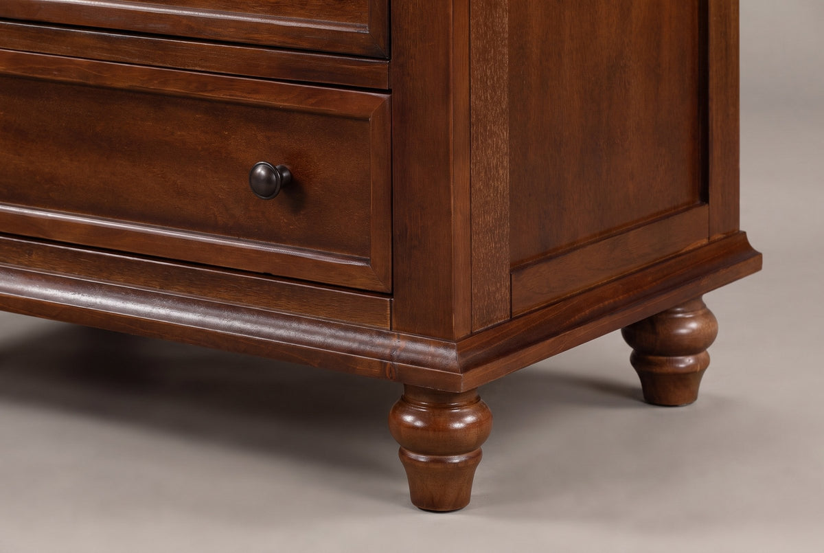 Close-up of the Nervi base: the moulded plinth, the framed side panel and a turned bun foot