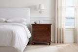 Nervi nightstand in Brown beside a bed with white linen in a bright Halifax bedroom with a harbour view