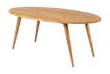 Nolan solid acacia oval dining table in honey with splayed tapered legs, three-quarter view