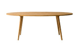 Nolan solid acacia oval dining table, side view of the top edge and tapered legs