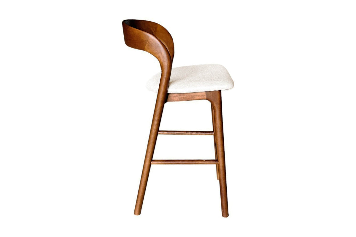 Norwood counter stool, side view of the sculpted back flowing into the rear leg
