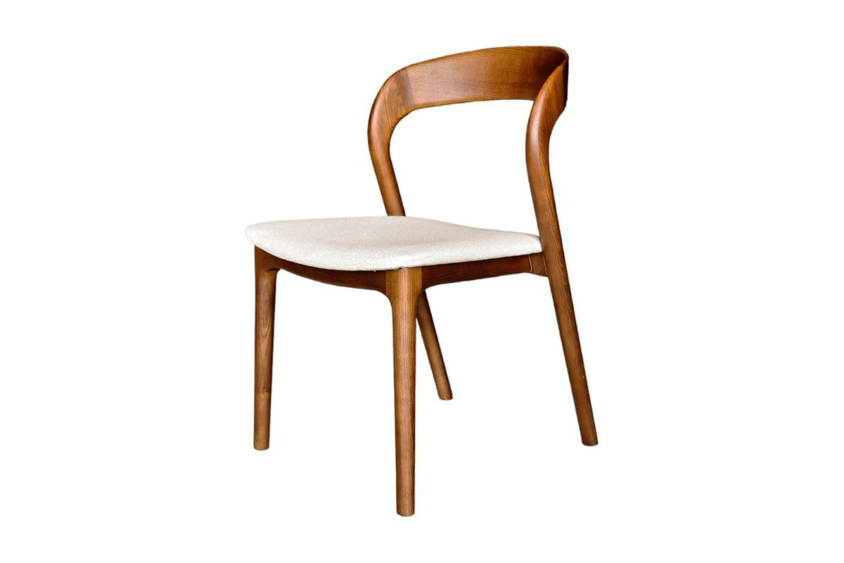 Norwood solid ash dining chair in walnut with cream fabric seat, three-quarter view