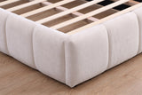 Close-up of the rounded foot corner, the channel-tufted rail blocks and the wood slats