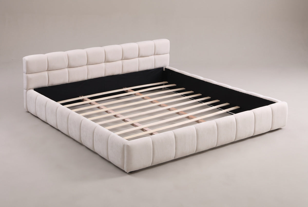 Noto tufted chenille platform bed in beige, three-quarter view on a warm grey studio backdrop with the wood slats showing