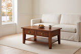 Novella coffee table in African Dusk in front of a white linen sofa in a North Hatley sitting room, autumn maples through the window