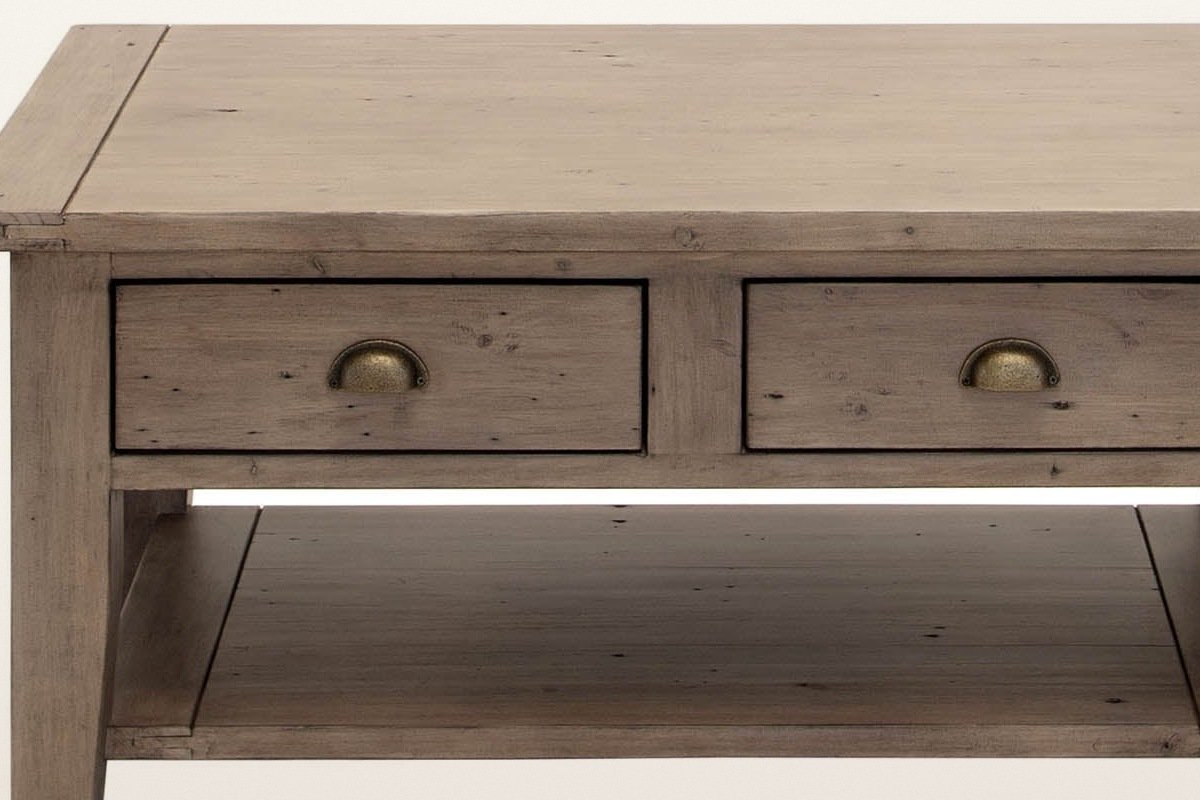 Close-up of the Novella coffee table front in Sundried: the plank top, the two drawers and their antique brass cup pulls
