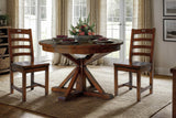 Two Novella dining chairs at a round pedestal table in a sunlit dining room