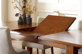 Butterfly leaf rising from the centre of the Novella dining table in a bright dining room