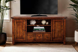 Novella media console holding a TV, books and decor between two tall plants