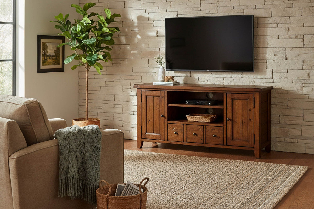 Novella media console below a wall-mounted TV in a living room with a stone accent wall