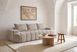The Nuvola sofa in Camel under a white vaulted ceiling in a Puglian masseria, with a travertine coffee table