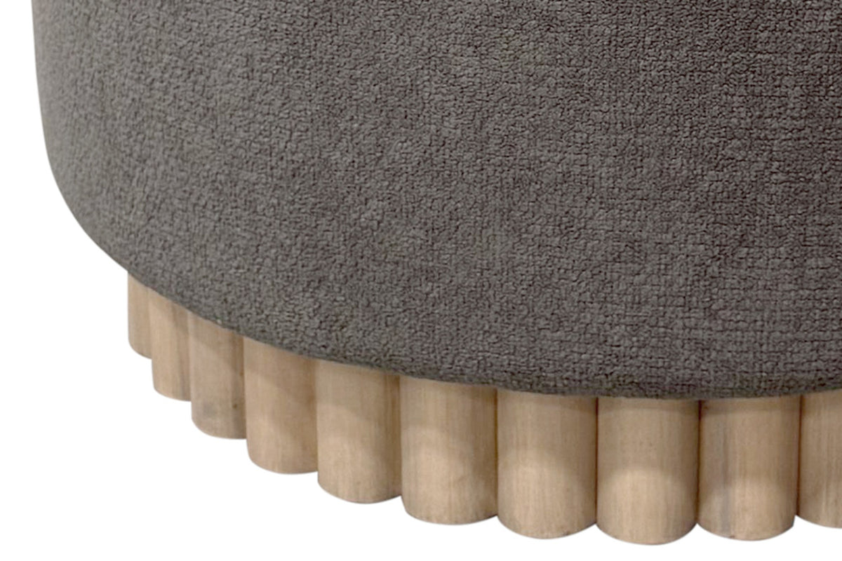 Close-up of the Nyla reeded natural wood base under warm charcoal fabric