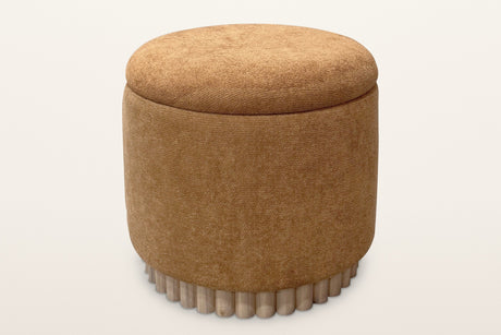 Nyla round storage ottoman in rust chenille on a reeded light-wood base, seen from slightly above on a warm white studio backdrop