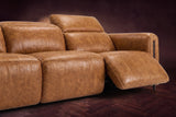 The Octavia 3 seat in Antiqued Caramel distressed full leather on a dark herringbone floor, close on the right recliner, open with its headrest raised. Shown in Antiqued Caramel, 3 seat.