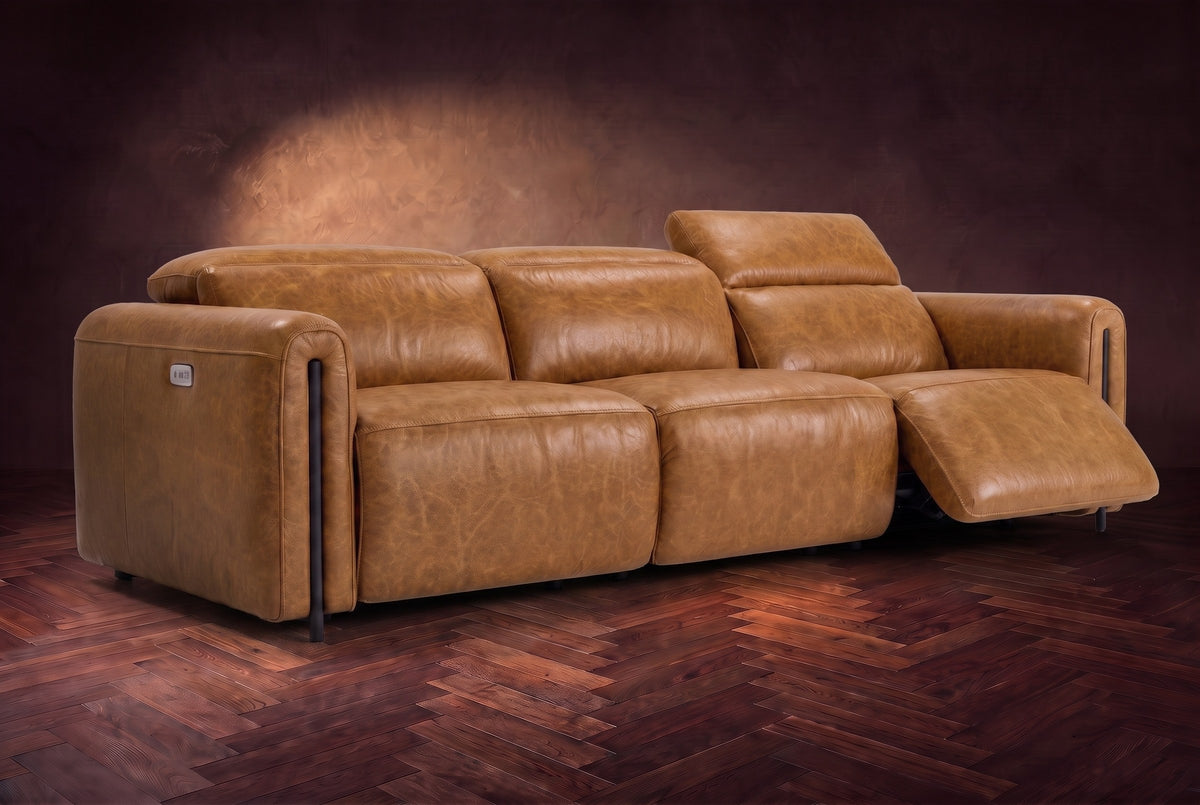 The Octavia 3 seat in Antiqued Caramel distressed full leather on a dark herringbone floor, the right recliner open and its headrest raised. Shown in Antiqued Caramel, 3 seat.